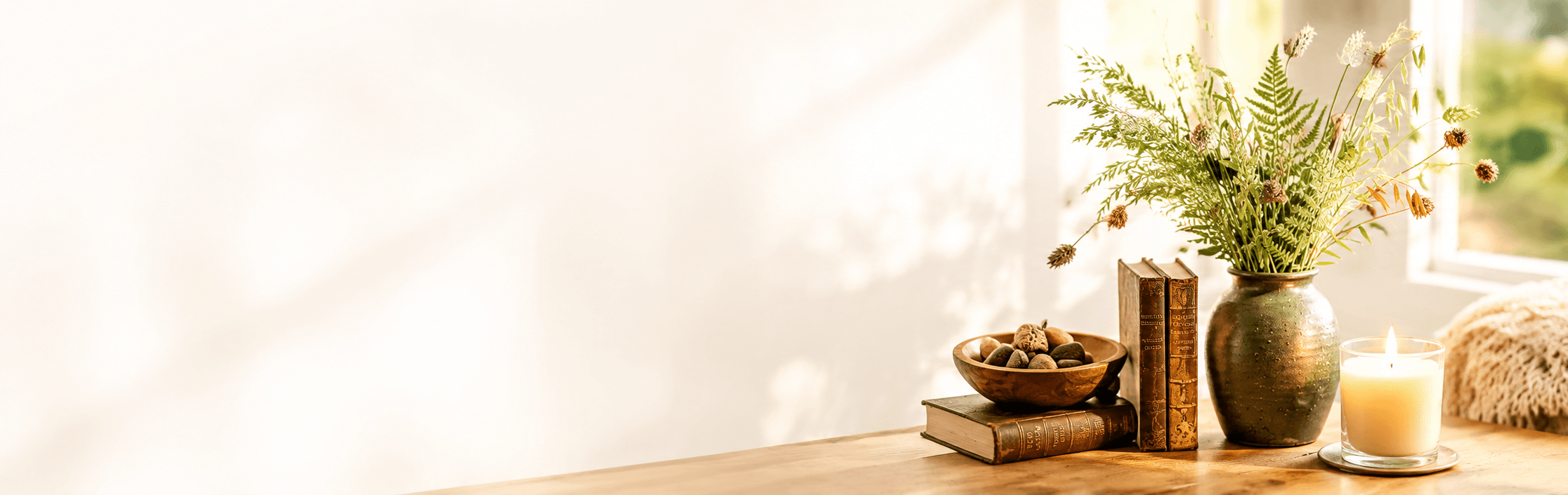 Aesthetic calm setting with a burning candle, vase, dried golden branches, and notebook
